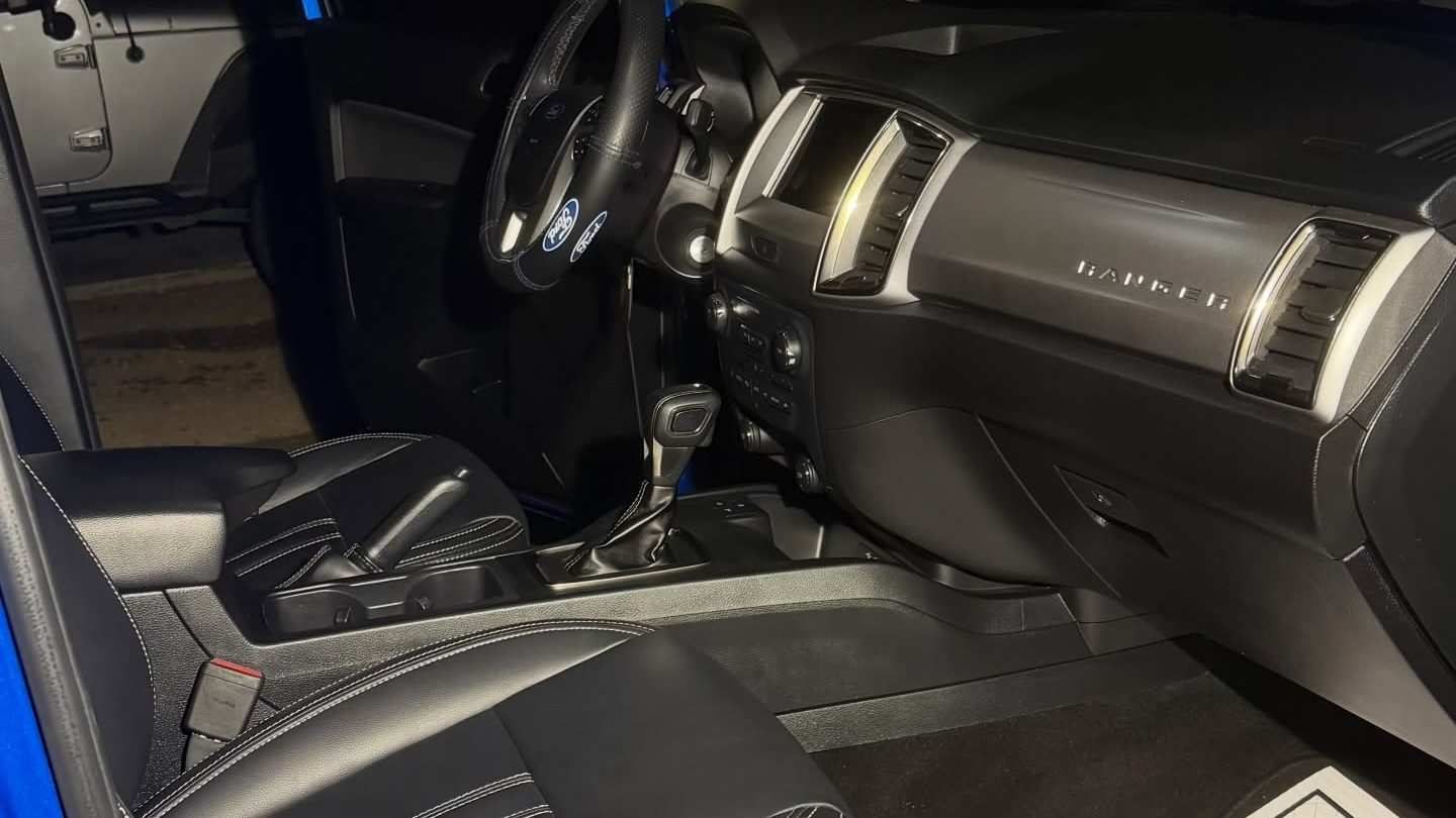 A cleaned vehicle interior photographed from the driver door