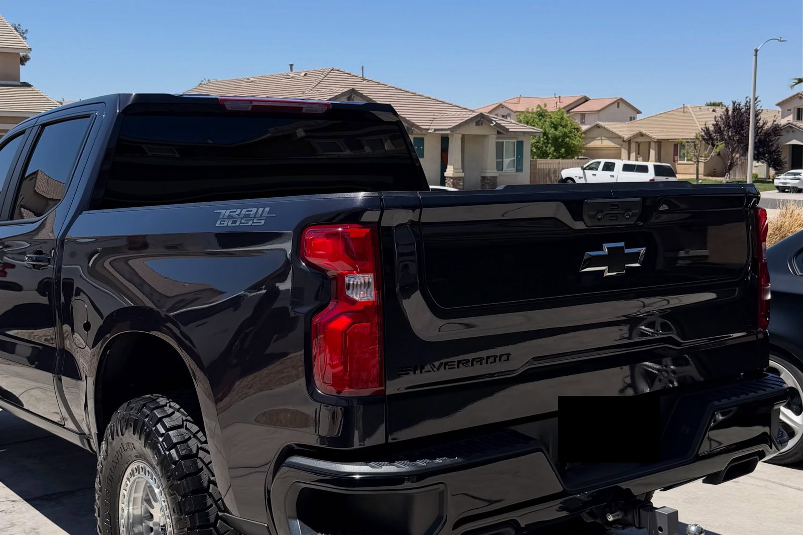 A black Chevrolet Silverado Trail Boss detailed on a residential street