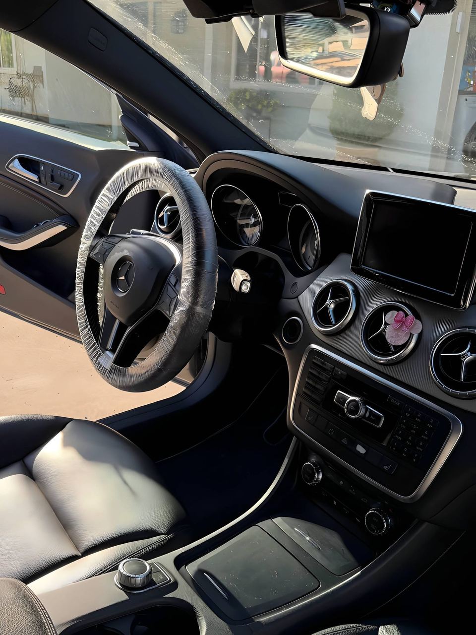 Mercedes-Benz CLA dashboard and steering wheel, wheel wrapped in protective film