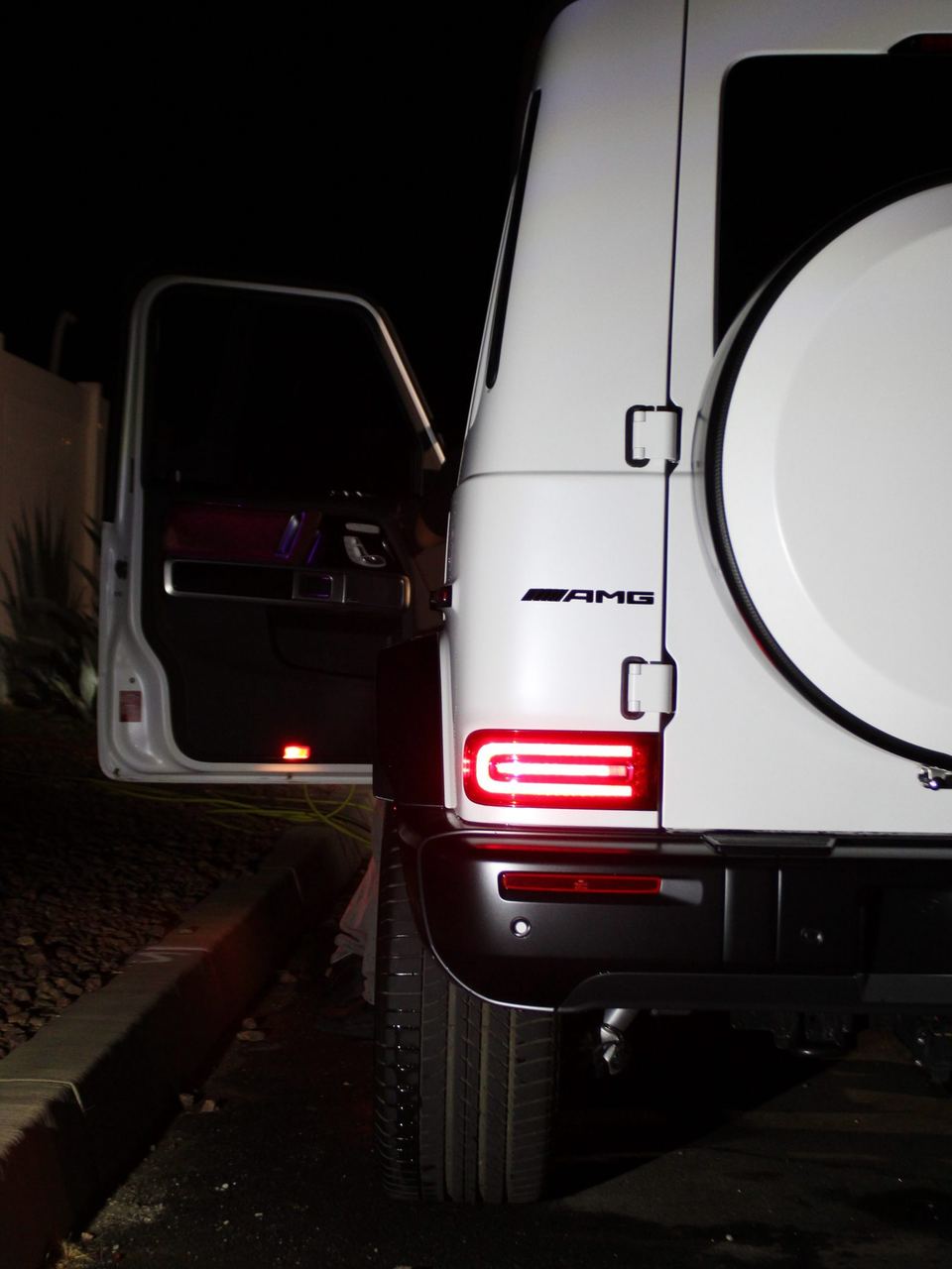 Mercedes-AMG G63 rear panel, AMG badge and taillight at night