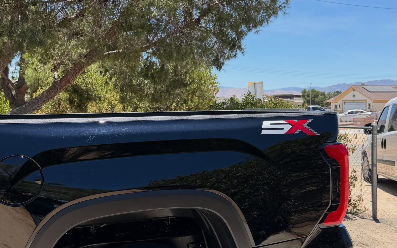 A truck's bed rail and taillight after paint correction
