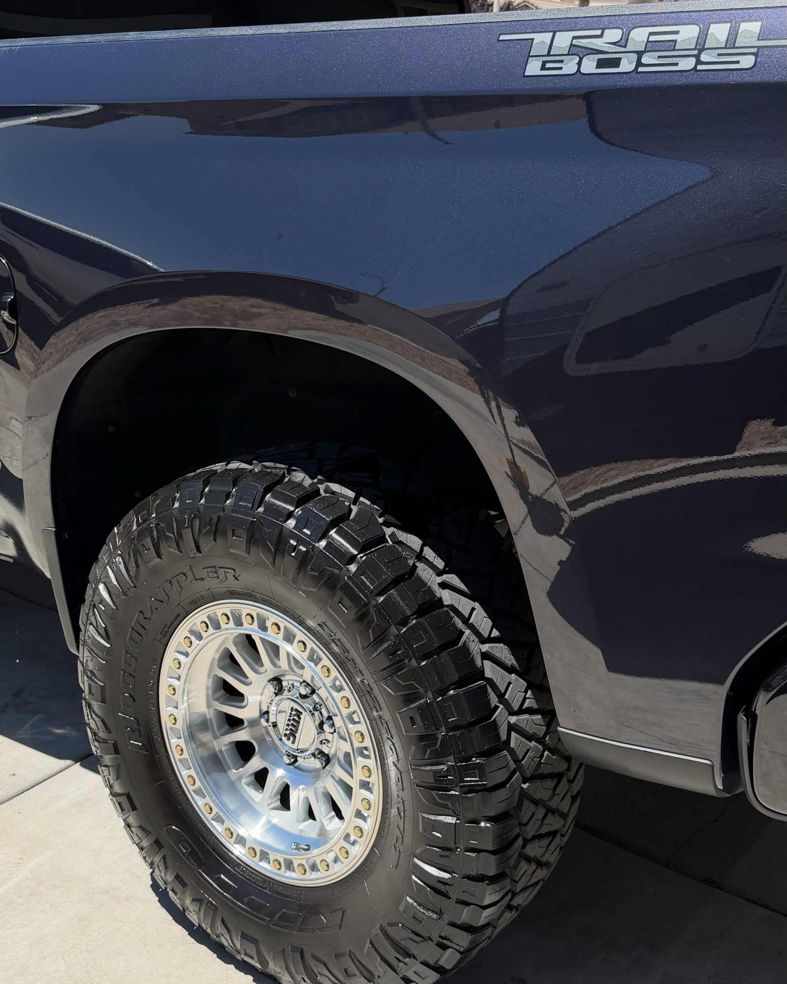 A dark truck being hand washed in a High Desert driveway