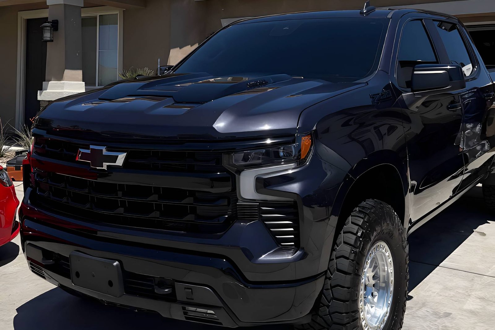A dark truck being hand washed in a High Desert driveway