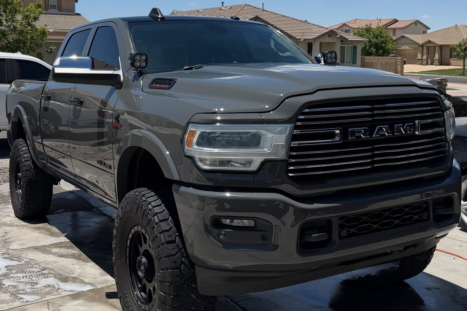A maintained vehicle being hand washed on a residential driveway