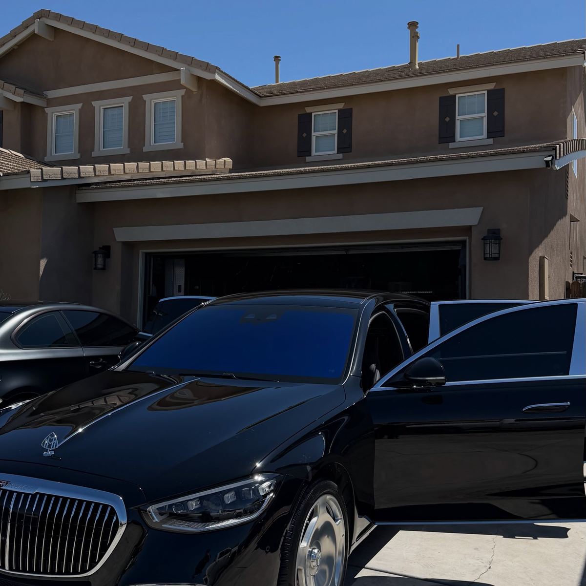 Two black Mercedes-Maybach sedans parked nose to tail