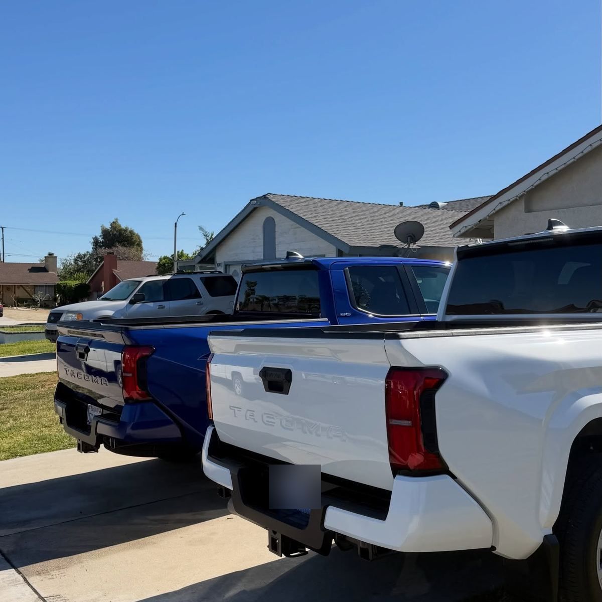 A white Chevrolet Silverado kept clean in a client driveway