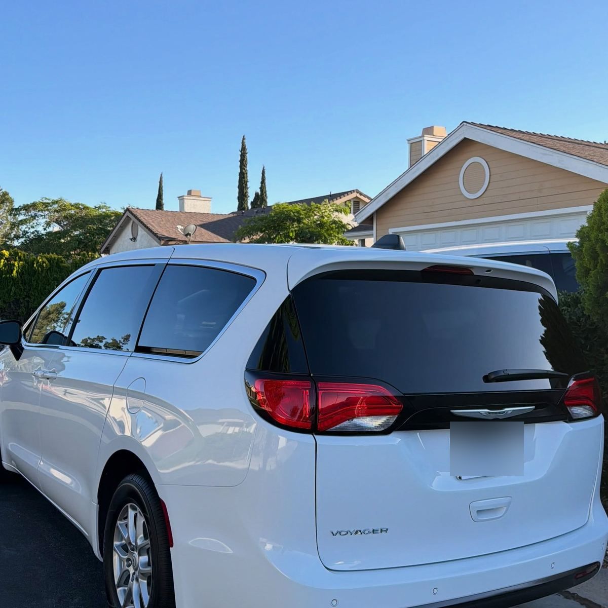 The rear of a white Chrysler Pacifica after a maintenance visit